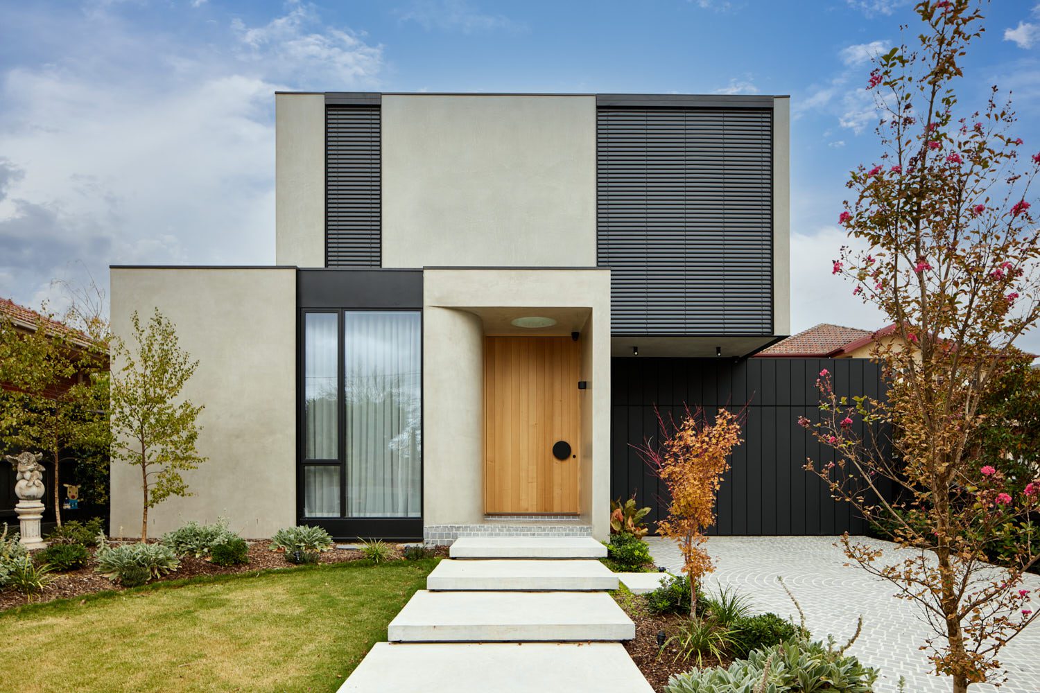 Modern home facade with Wave Fold Sheer Curtains in the front window