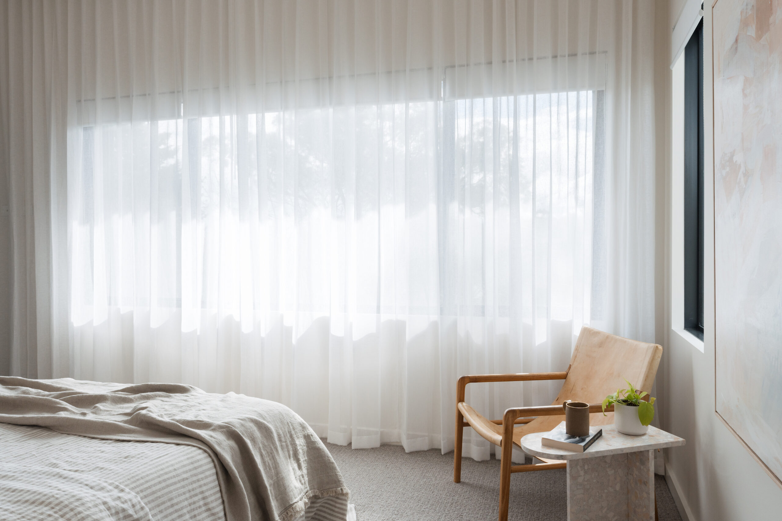Floor to ceiling wave fold sheer curtains in master bedroom