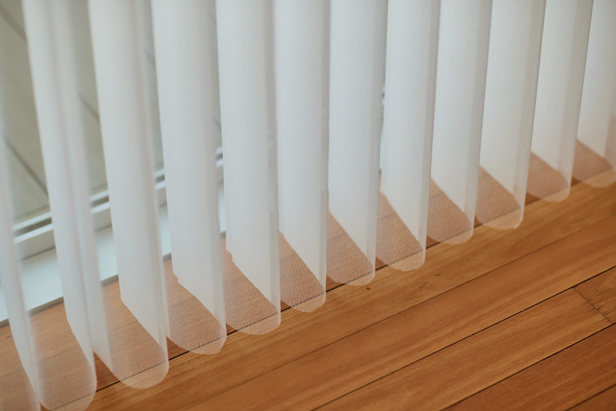 Off-white Veri Shade Blinds gently floating above the floor